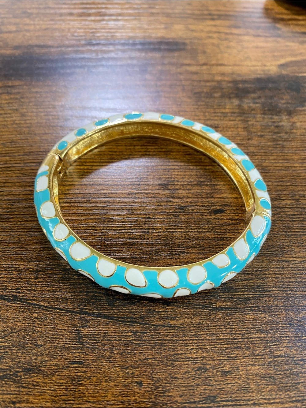 Signed KJL turquoise, white and gold tone enamel clamper magnetic bracelet.